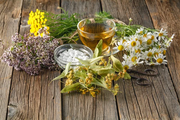 Ancient herbal medicine on wooden background
