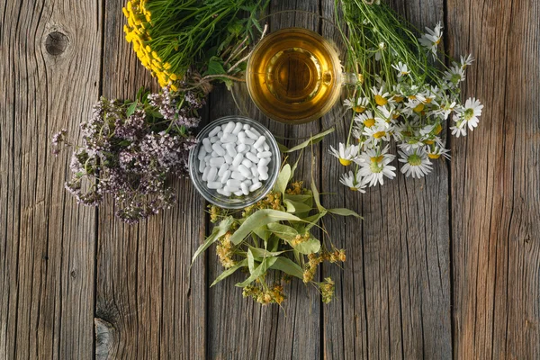 Ancient herbal medicine on wooden background