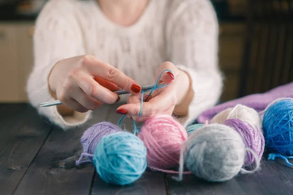 Woman\'s hand knitting scarf, handcraft.