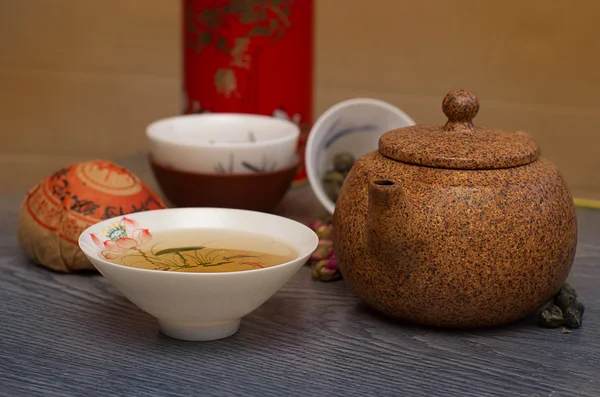 Chinese clay teapot and cups on wooden table