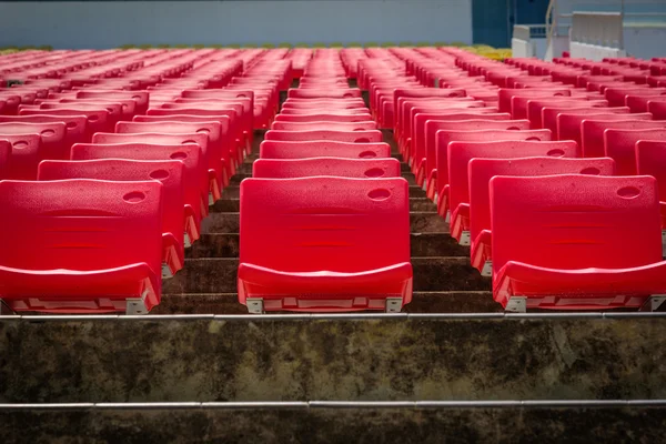 Empty red seats in football stadium.