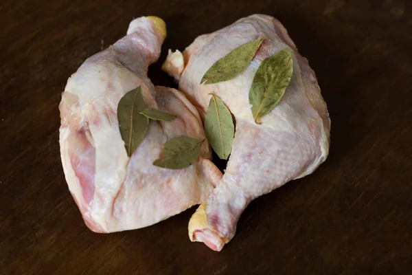 Raw chicken legs and bay leaf