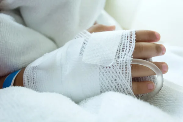 Hand illness asian kids a sickbed, saline intravenous (IV) on hand
