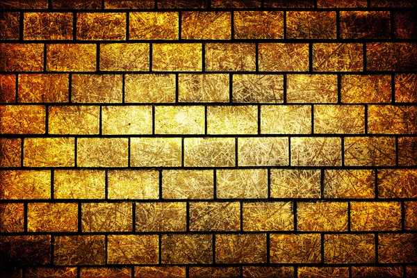 Texture of golden decorative tiles in form of brick high contrasted with vignetting effect scratched styled