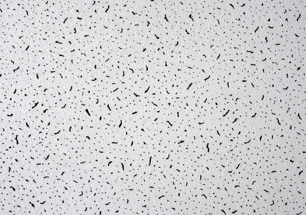 White abstract grunge paper macro texture with black spots