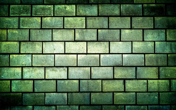 Texture of green decorative tiles in form of brick high contrasted with vignetting effect