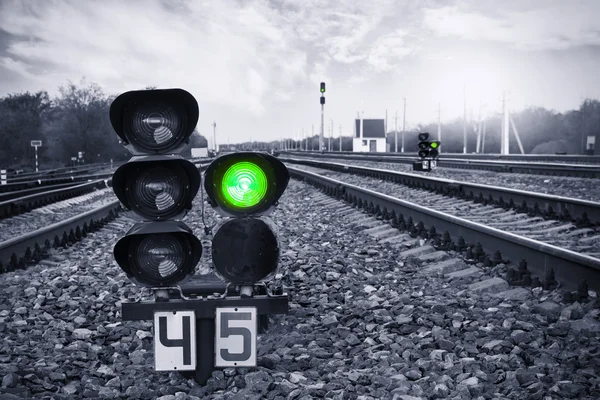 Traffic light shows green signal on railway