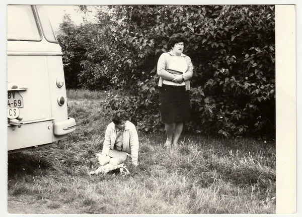 Vintage photo shows women have a rest during long bus trip.