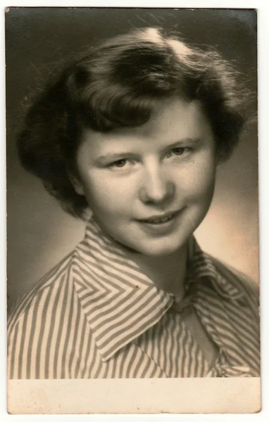 Retro photo shows young woman (studio portrait). Black & white vintage photography.