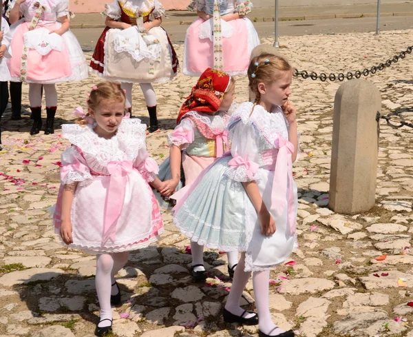 Celebration the Feast of Corpus Christi (Body of Christ) also known as Corpus Domini. Small girls wear folk costumes.