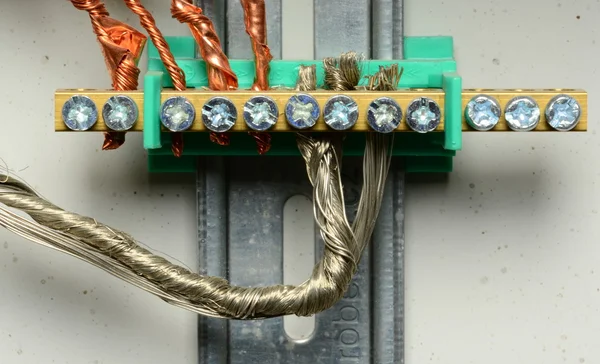 Closeup of electrical distribution board. Connection of color wires. Copper bare wires.
