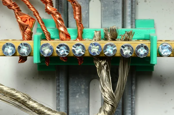 Closeup of electrical distribution board. Connection of color bare wires (copper and aluminium).