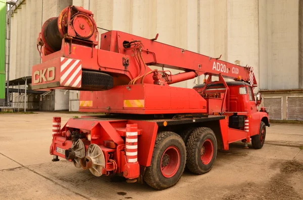 Red mobile crane Tatra AD 20. The truck-mounted crane AD 20 is determined for building and assembly works also in heavy terrain. The truck was made in 1978.