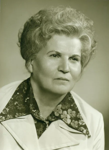 Retro photo shows studio portrait of an elderly woman. Vintage black & white photography.