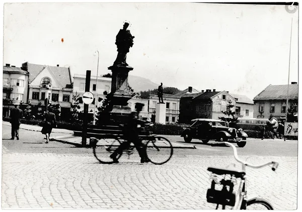 Retro photo shows a view of the city street (square). Black & white vintage photography