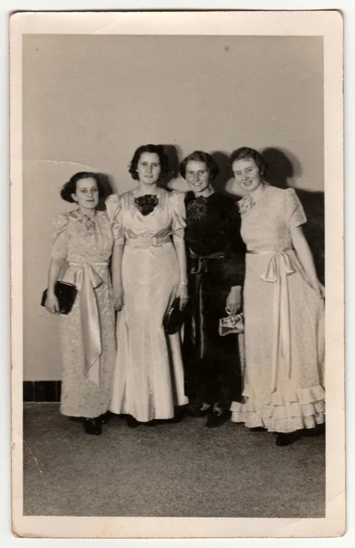 : Vintage photo shows a dancers - girls pose during the dancing lessons. Retro black & white photography.