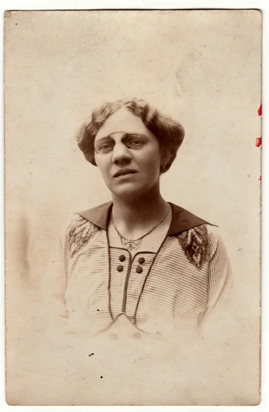 Vintage photo shows a mature woman wears vintage antique nose clip glasses. Retro black & white photography. Photo was taken in Austro-Hungarian Empire or also Austro-Hungarian Monarchy.