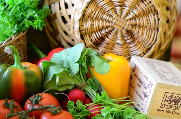 Tomatoes, radishes, peppers, parsley and wickerwork handbasket