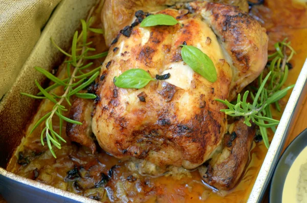 Roasted chicken with herbs and rice on wooden background