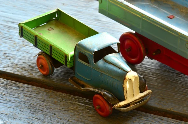 Set of vintage toys - trucks (lorries) toys on blue wooden background