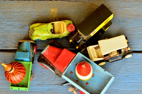 Set of vintage toys - convertible toy car, trucks (lorries) toy, post car toy and spinning (humming) tops