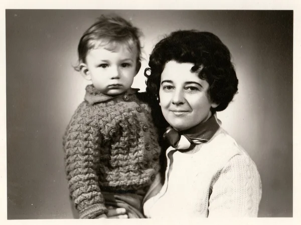 Retro photo of mother and her son.  Portrait photo was taken in photo studio. Early seventies
