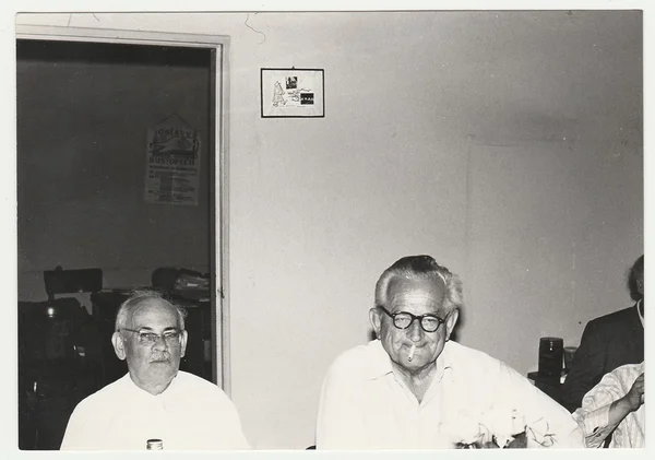 Vintage photo shows men in the office, circa 1980s.