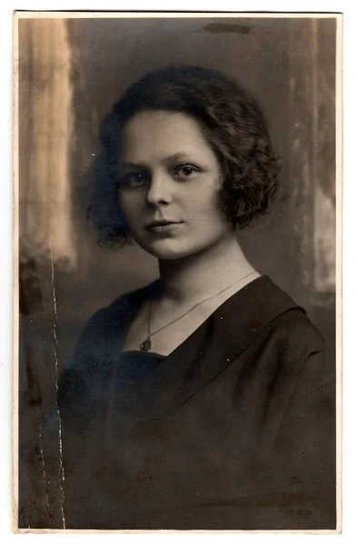 Vintage photo of a young woman with mysterious look