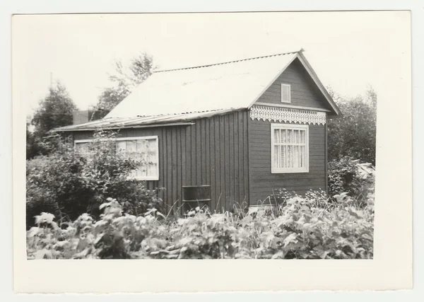 Vintage photo shows a gardening cabin. Black & white photo.