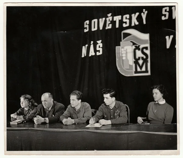 Vintage photo shows communist meeting of young people.