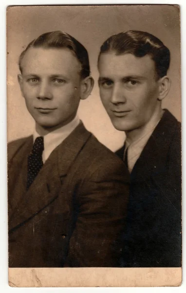 Vintage studio photo portrait shows young men. An antique Black & White photo
