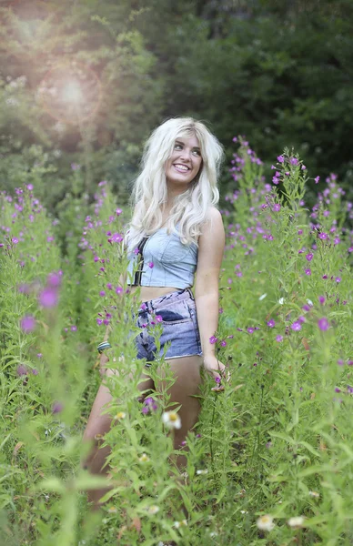 Beautiful young woman in long grass