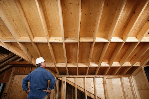 Construction worker inspecting home addition.