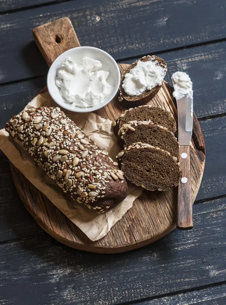 Rye baguette and feta cheese on a rustic wooden board. Healthy tasty food