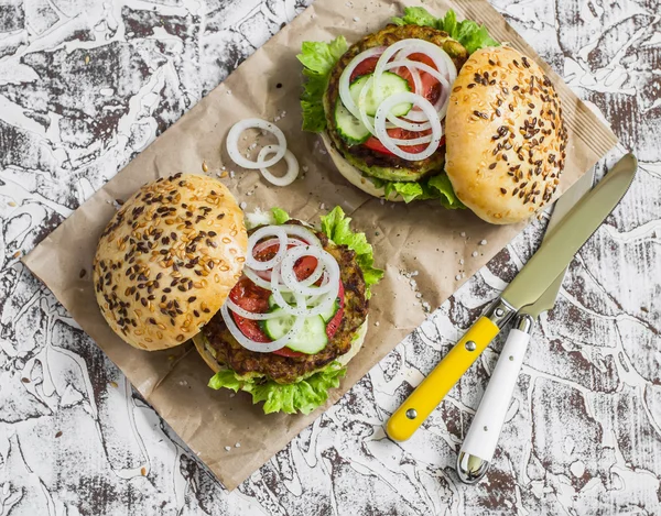 Healthy vegetarian zucchini fritters  burgers on light background.