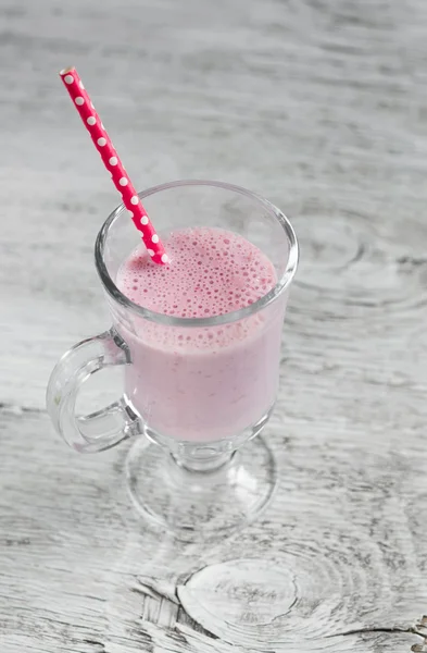 Cocktail with strawberries, ice cream and milk in a glass mug