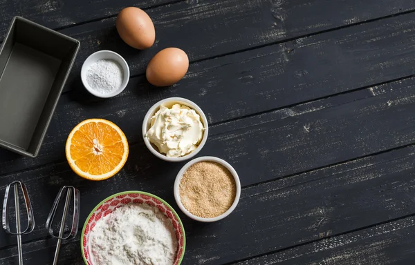 Raw ingredients - flour, eggs, butter, sugar, orange - to cook orange cake. Ingredients for baking. Ingredients for the dough.