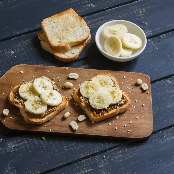 Sandwich with peanut butter, banana and peanuts, served on the Board