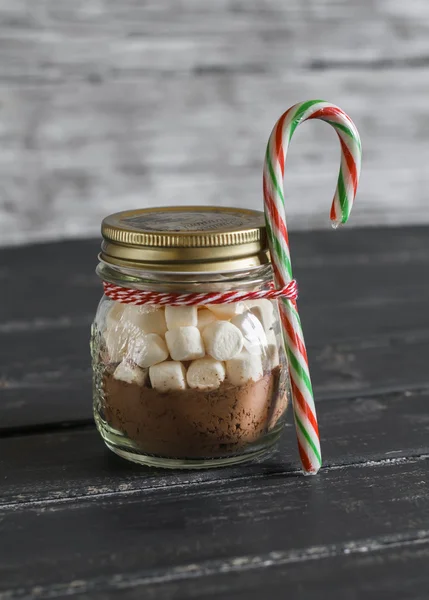 Homemade Christmas gift - ingredients for making hot chocolate with marshmallows in a glass jar