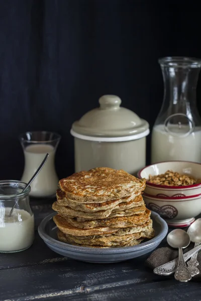 Healthy breakfast or snack - whole grain pumpkin pancake, on a dark wooden table