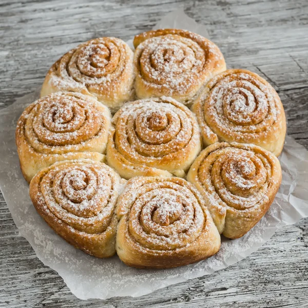 Sweet buns on a light rustic wood surface