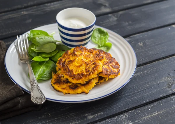 Pumpkin pancakes and fresh spinach. Healthy food