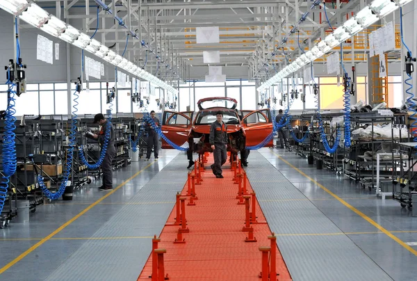 People work in the car factory
