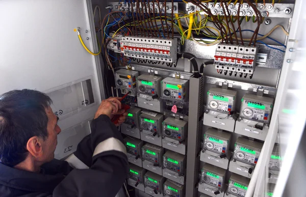 Electrician builder engineer inspecting electric counter equipment