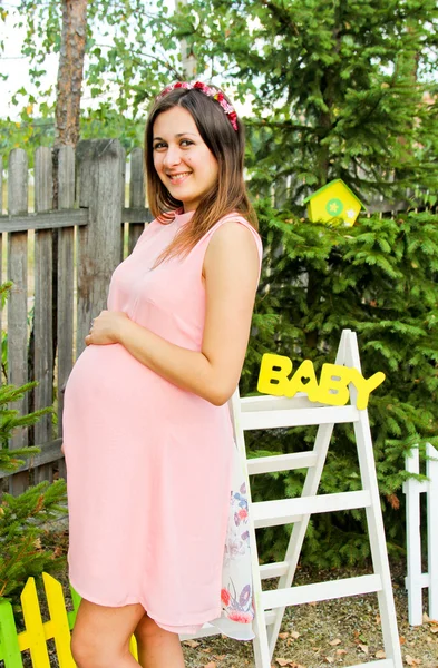 Beautiful pregnant woman outdoor with decorations.