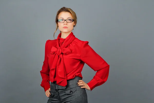 Woman in red blouse and glasses