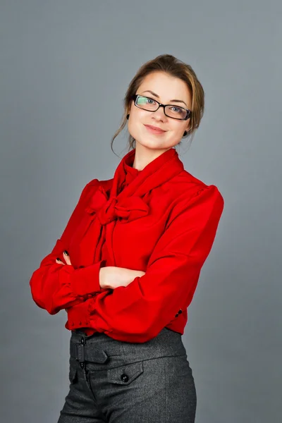 Woman in red blouse and glasses smile for camera