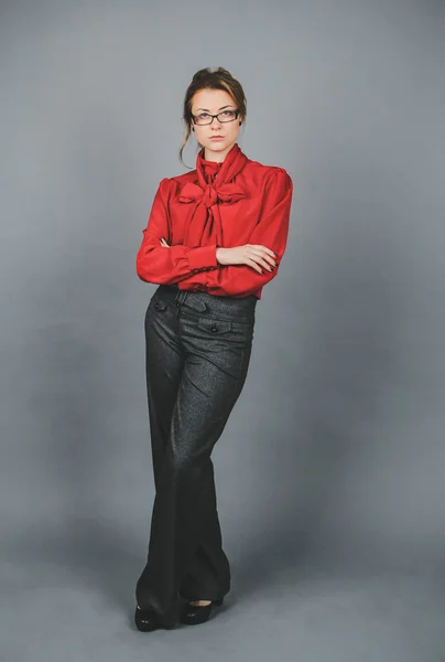 Seriouse woman in red blouse and glasses