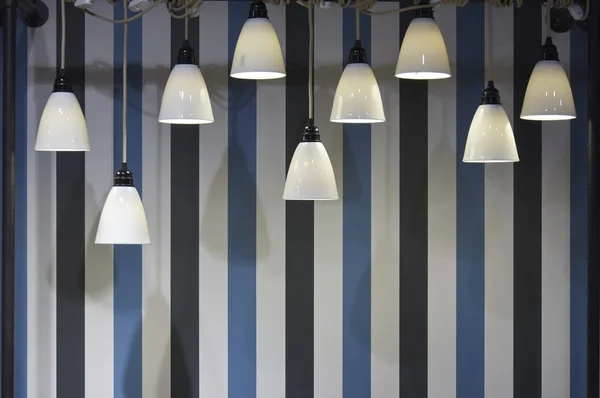Decoration lights in front of a striped wall