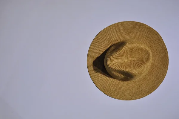 Brown straw hat on a white table